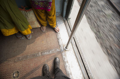 Low section of woman standing on tiled floor