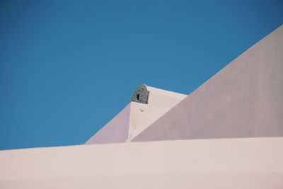 Low angle view of building against clear blue sky