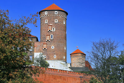 Low angle view of old building against clear blue sky