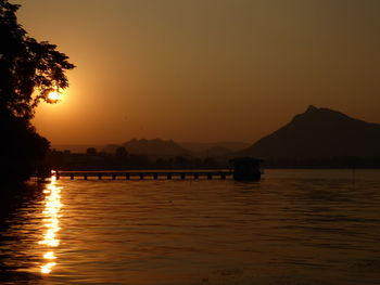 Scenic view of lake against orange sky