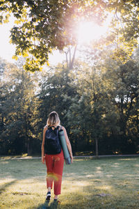 Rear view of woman standing on field