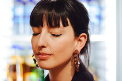 Close-up of young woman with eyes closed