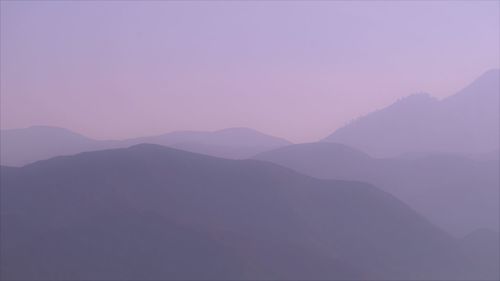 Scenic view of silhouette mountains against sky during sunset