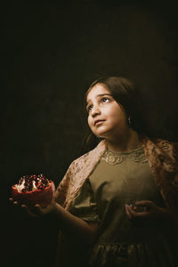 Portrait of young woman holding food