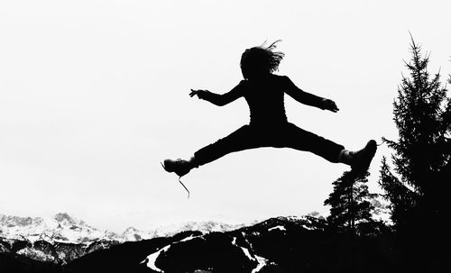 Low angle view of a woman jumping