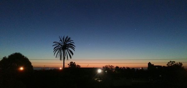 Silhouette of trees against sky at sunset