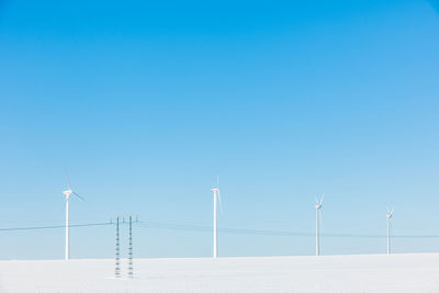 Wind turbines on snowy field