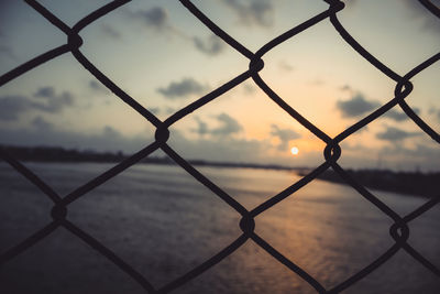 Full frame shot of chainlink fence against sky