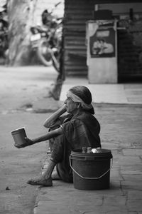 Woman sitting with umbrella