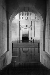 Man passing by a memorial gate.