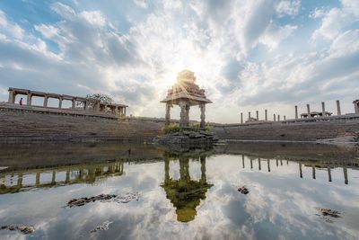 Panoramic view of lake and buildings against sky