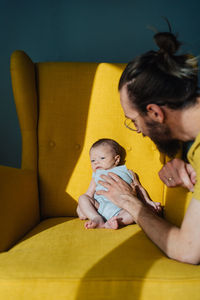 Mother and baby sitting at home