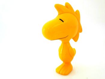 Close-up of yellow toy over white background