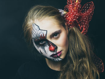 Portrait of beautiful woman against black background