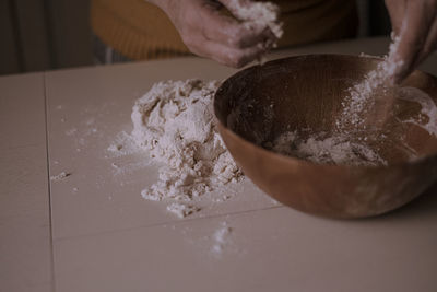 Close-up of person preparing food on table