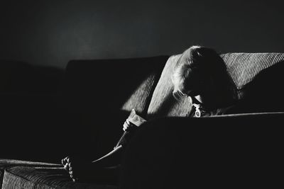 Man sitting on sofa at home