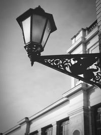 Low angle view of illuminated street light against sky