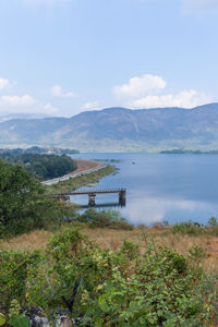 Scenic view of lake and mountains against sky