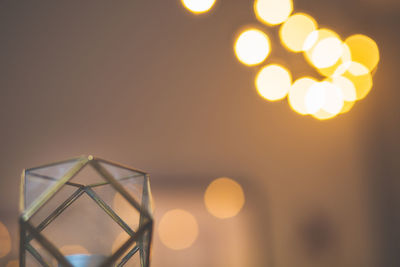 Close-up of illuminated lights against sky at sunset