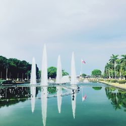 Swimming pool by lake against sky