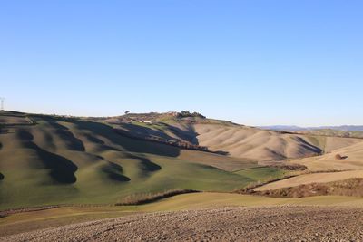 Scenic view of desert against clear blue sky
