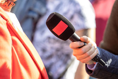 Reporter holding microphone making media interview. street interview or vox popoli.