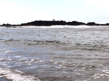 Scenic view of beach against clear sky