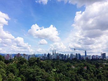 Panoramic view of trees and buildings against sky