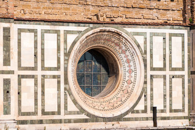Close up of circular window on florence cathedral architectural background