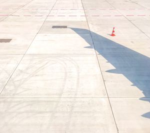 High angle view of aircraft wing shadow on runway