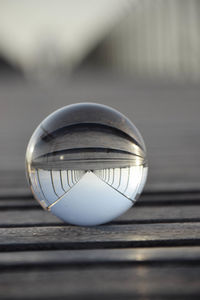 Close-up of crystal ball on wooden table