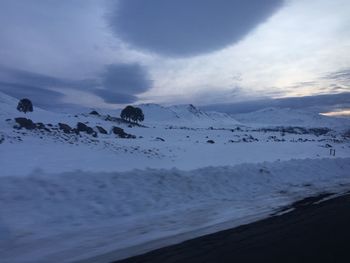 Scenic view of mountains against cloudy sky