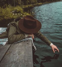 Man sitting by lake