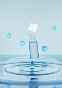 Close-up of water drop against blue background