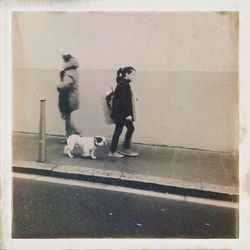 Full length of woman standing on wall