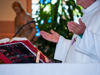 Midsection of priest standing in church