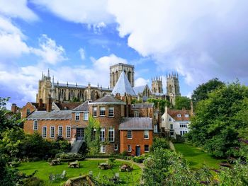 Panoramic view of old building and trees against sky