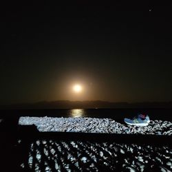 Scenic view of sea against clear sky at night