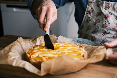 Midsection of woman holding pizza