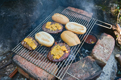 High angle view of meat on barbecue grill