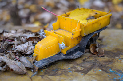 Close-up of yellow broken toy on land