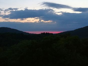 Silhouette of mountains against cloudy sky