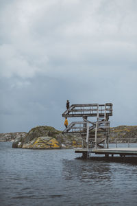 People on diving tower at sea