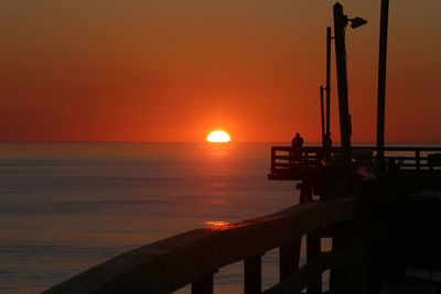 Scenic view of sea against orange sky