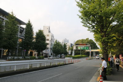 Road by city against sky