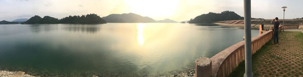 Panoramic view of lake against sky during sunset