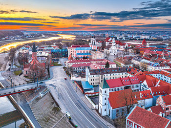 High angle view of illuminated cityscape against sky during sunset