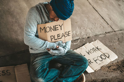 Man holding paper with text