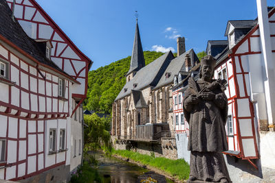 View from an old bridge on river elz and half-timbered houses in monreal, eifel, germany