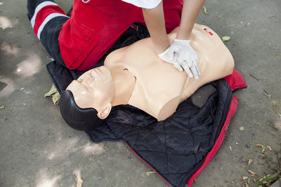 Low section of woman applying cpr on dummy